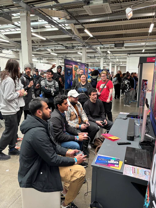 Crowd in front of Outrage: Fight Fest booth while 4 players try out the game.
