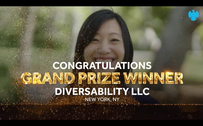 Screenshot from the announcement video with Tiffany laughing in the back. Text, “Congratulations grand prize winner. Diversability LLC. New York, NY”