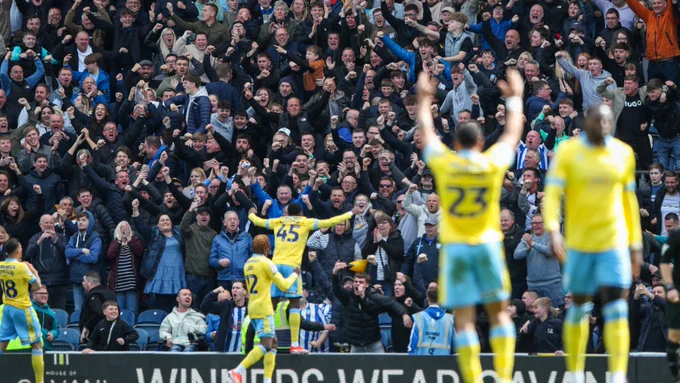 Sheffield Wednesday's players celebrate in front of a mass travelling of away fans at Ewood Park after a goal in their recent 3-1 win over Blackburn Rovers.