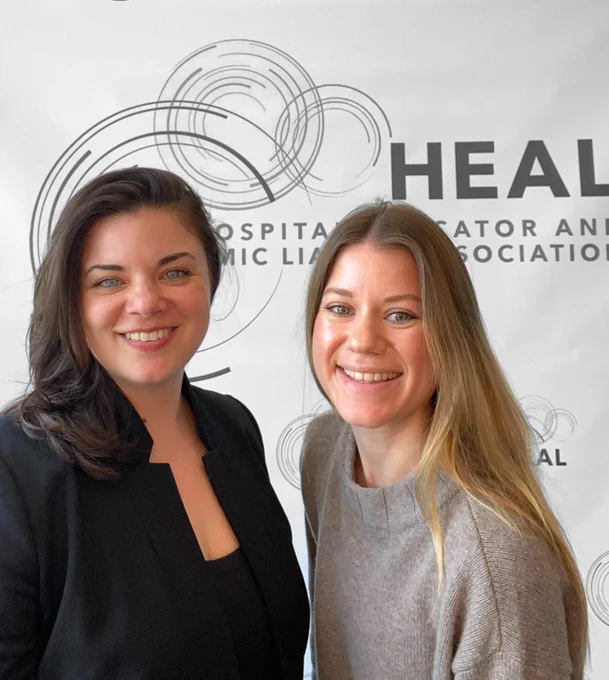 Dr. Lisa Carey & Dr. Laina Parrillo in front of HEAL association sign
