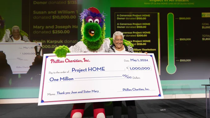 The Phanatic presents $1 million, on behalf of Phillies Charities, to Estelle Richman with PROJECT Home at the 35th anniversary gala celebrating the organization’s tremendous impact on the community and its co-founders.
