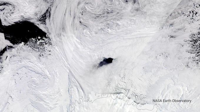 White sea ice, with opening revealing sea water below. Arial view of Maud Rise polynya. Credit NASA Earth Observatory