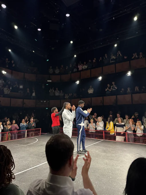 stage photo of the three main actors clapping with the audience after the show

stage looks like a football pitch and is surrounded by the audience on all sides