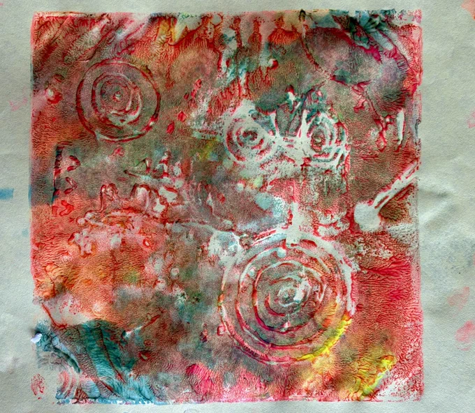 A photo of a multicoloured print with cup and ring marks.