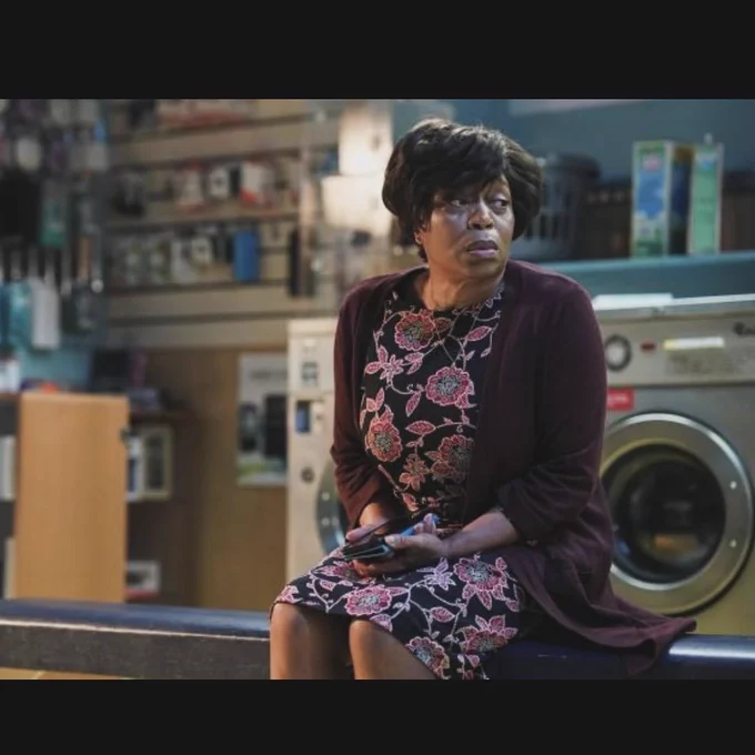 Image is still from an episode of EastEnders, which has Yolande looking upset in the Laundrette