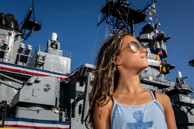 An LA Fleet Week® event attendee stands in front of Battleship IOWA at the Port of Los Angeles.