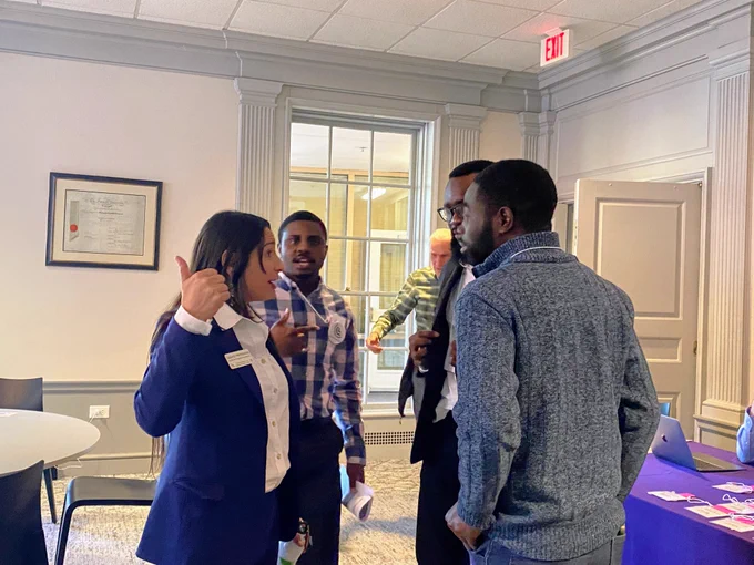 Olamiposi is having a discussion at the Citizens Climate Lobby (CCL) Southeast conference in Greenville, South Carolina, with his colleagues and Solemi.