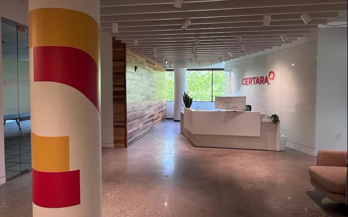 The lobby of an office with the Certara logo above the front desk.