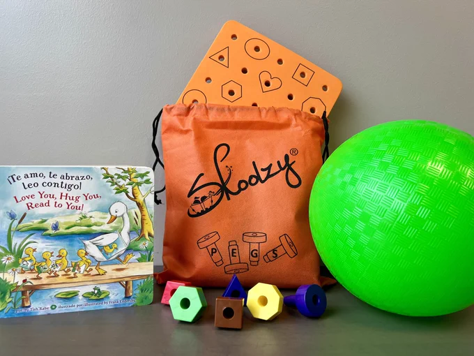 children's book, peg puzzle, and ball
