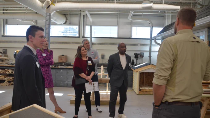 Commissioner Jett, Superintendent Jeff Ronnenberg, Michelle Kamenov, Jeanna Fortney and Rep. Matt Norris listen to teacher Scott Wicklund share about his construction class. 