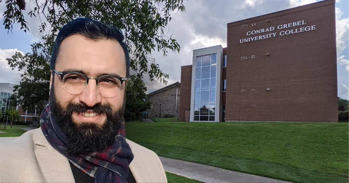Afnan Aleem portrait in front of Conrad Grebel University College building