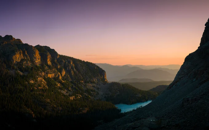 https://unsplash.com/photos/a-mountain-with-a-lake-in-the-middle-of-it-O_QJLYPvqa4