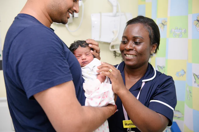 Midwife helping parent