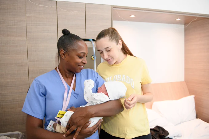 Midwife holding baby