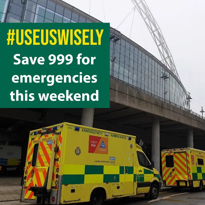 Image shows London Ambulances parked outside Wembley Stadium. Message reads: ‘Use us wisely - save 999 for emergencies this weekend’ 