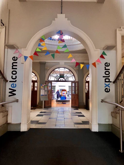Entrance of Explore Library with bunting above the arched entry