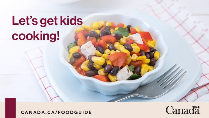A bowl of black bean corn salad, a food guide kitchen recipe. Text reads: Let’s get kids cooking!
