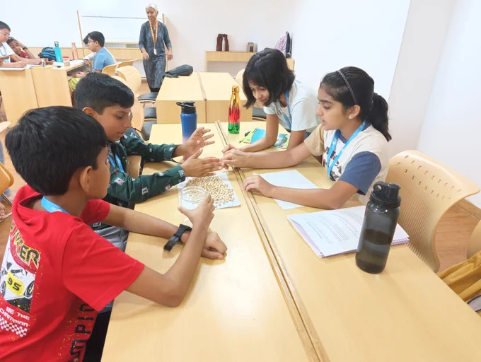 Students at the GiftedSummerProgram doing a quick estimation of the # of chickpeas in a small jar (without counting them)