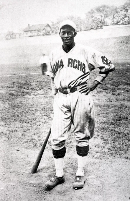 Newt Allen in KC Monarchs uniform with baseball bat in right hand.