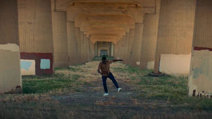 Dule dances underneath bridge