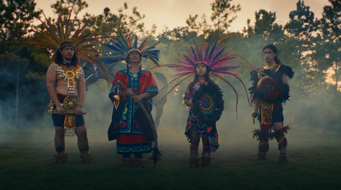 Rain Flowa stands alongside her family in traditional garb