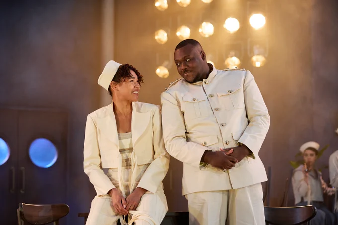 Viola and Orsino look at each other smiling. Both are dressed as sailors.