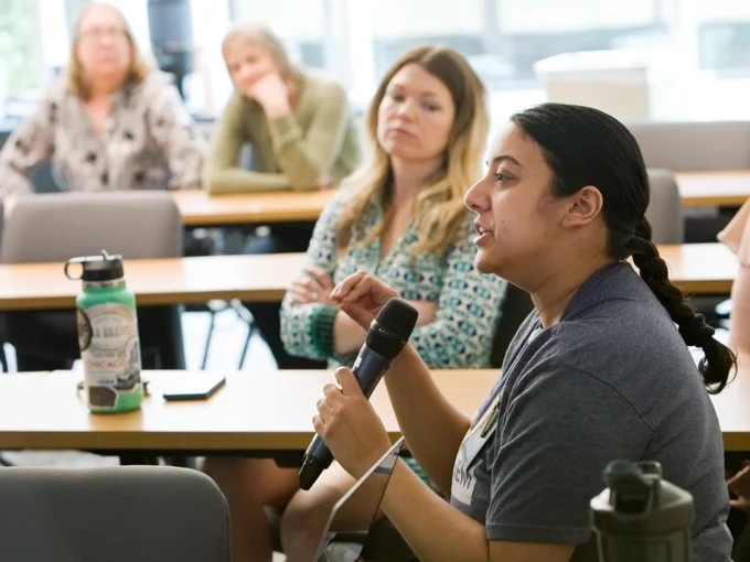 An audience member speaks into the microphone 