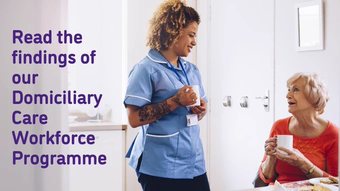 A Black homecare worker in blue uniform (standing) is drinking tea with an older white woman (sitting) in her kitchen - smiling and chatting. Text says: Read the findings of our Domiciliary Care Workforce Programme