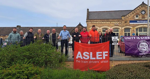 pickets and supporters in front of Workington station