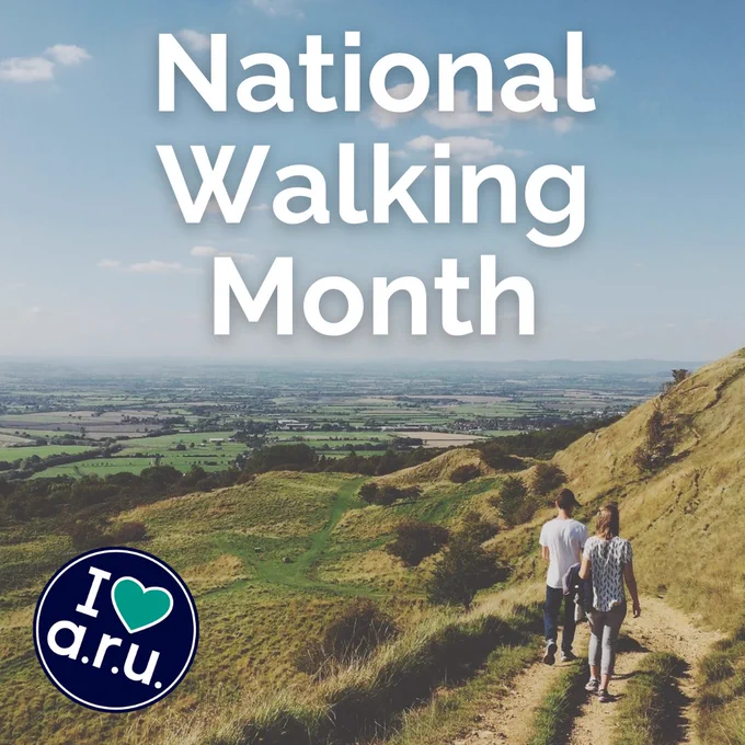 A photo showing two people walking in the countryside.