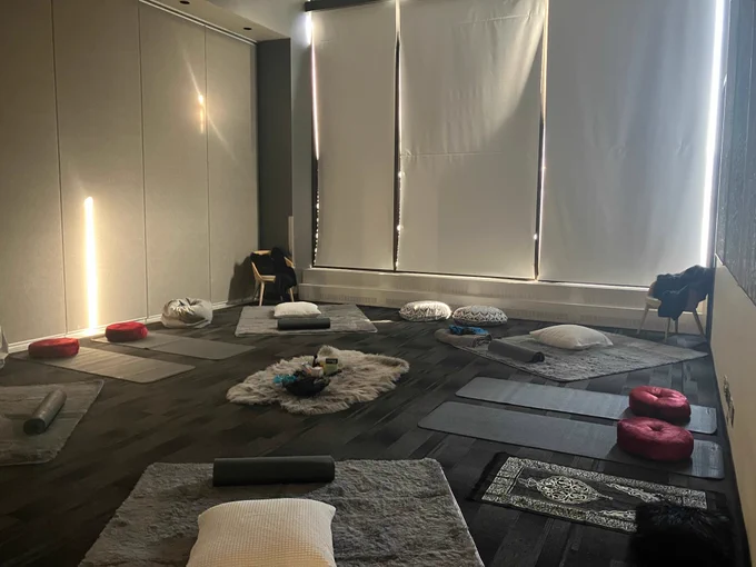 a cozy room with cushions, yoga mats and heavy blankets.