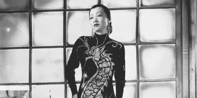 Chinese American actress Anna May Wong is seen wearing a long dress with a dragon embellishment by designer Travis Banton for her role in the 1934 film 'Limehouse Blues'. 