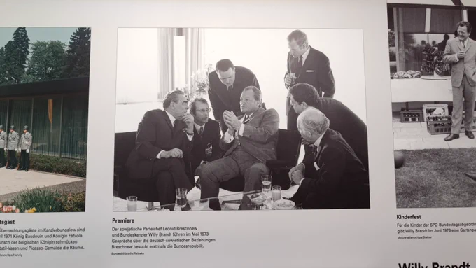 Leonid Brezhnev and Willy Brand in a meeting with their two interpreters whispering to them simultaneously whilst they listen.
