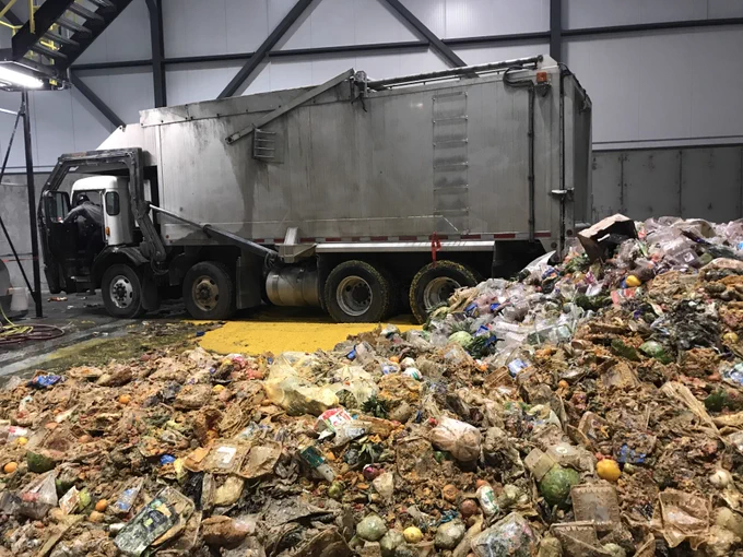 A pile of organic waste near a truck.