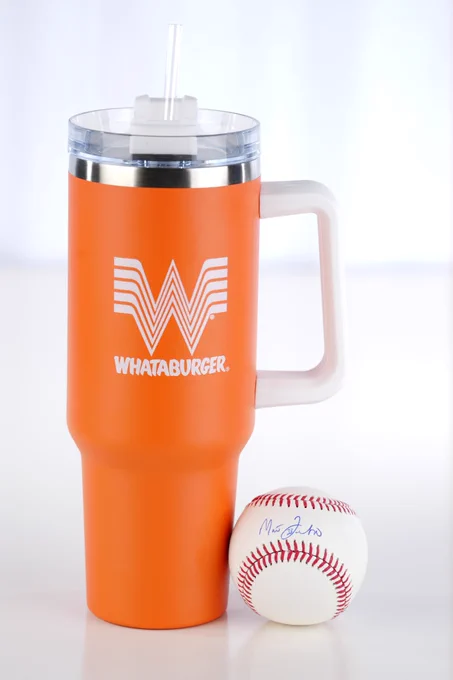 A photo of an orange and white Whataburger 40 oz. tumbler and a baseball signed by Royals manager Matt Quatraro.
