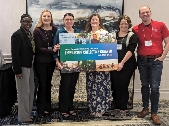 Leaders from Iowa's Vocational Rehabilitation division, Iowa Department of Education, and ASK Resources (Access for Special Kids) posing for a group photo while attending the 2024 Capacity Building Institute (CBI) in Charlotte, NC.
