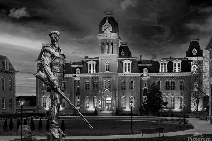 Dramatic black and white monochrome image of Woodburn Hall at West Virginia University or WVU in Morgantown WV with the famous Mountaineer statue composited into the photo. Available now in my store. 