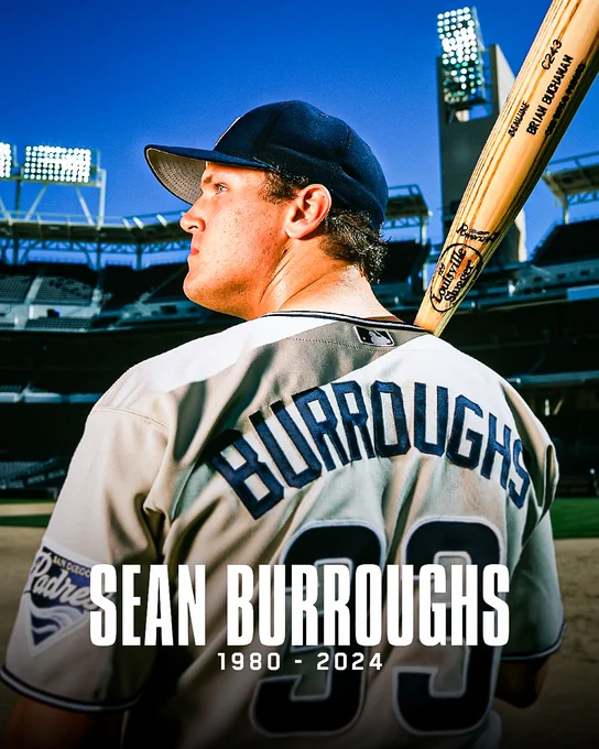 Graphic in memory of Sean Burroughs. The graphic features a photo of Sean at Petco Park. He is posing with his back to the camera and has his head turned to the left, looking up. He is wearing the Padres tan uniform with blue accents. He also has a bat resting on his right shoulder. White text at the bottom of the graphic reads "Sean Burroughs 1980-2024".