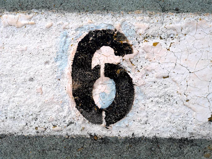 Close-up of Number 6 Painter on Cement