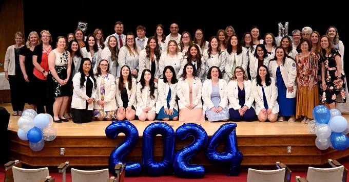 The nursing graduates pose with faculty.