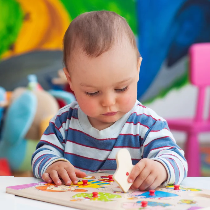 A child playing with a puzzle.