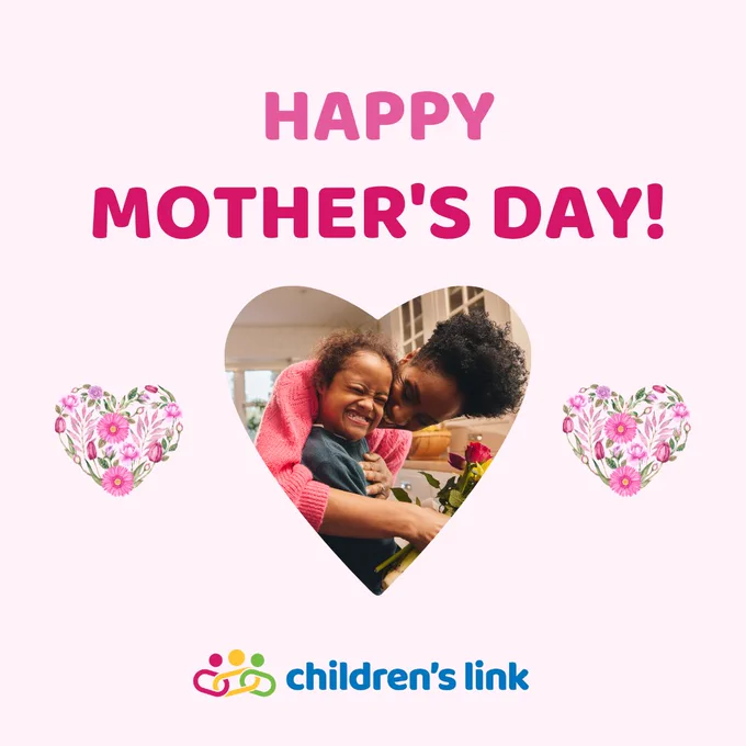On a light pink background, pink text reads: Happy Mother's Day!
There is a heart framed photo of a mother hugging her child with a disability in the kitchen while holding a bouquet of pink and yellow flowers. They are both smiling and laughing.