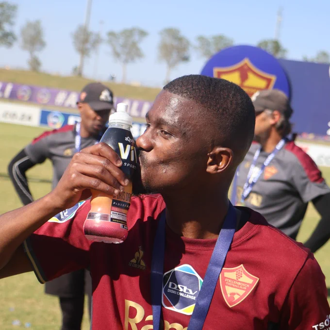 Thulani Mini enjoying a bottle of aQuelle ViV after helping Stellenbosch FC win the 2023-24 DStv Diski Challenge trophy.