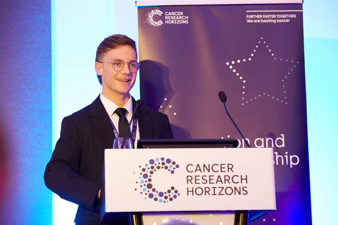 Matt De Vries receiving his award at the Cancer Research Horizons awards ceremony.