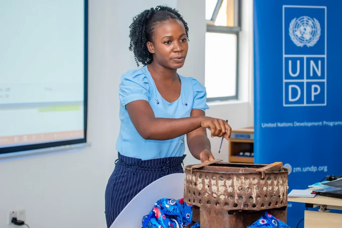 An image of a AccLab Zambia innovator, Mervis Ngosa, showing her innovation off - the Copper Slag Stove