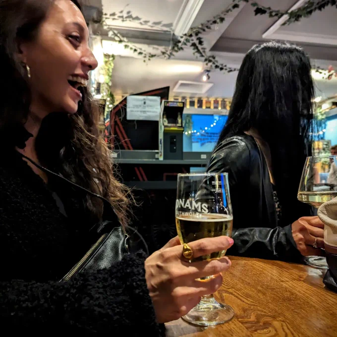 Two folks sitting, drinking and being merry