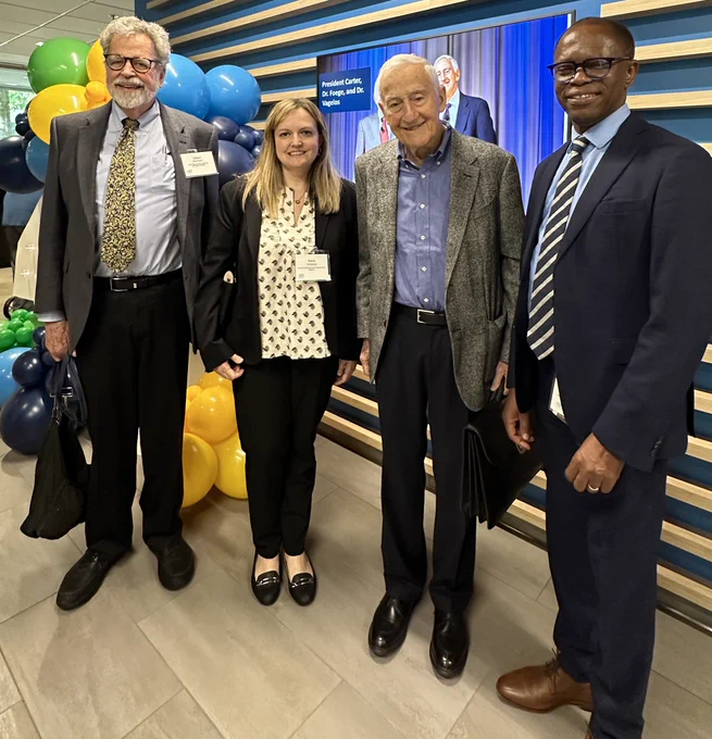 Pictured are the current Mectizan Expert Committee chair Professor Gilbert Burnham, Merck representative Maria Verbanac, Dr. Vagelos, and M.D.P. director Dr. Yao Sodahlon. 