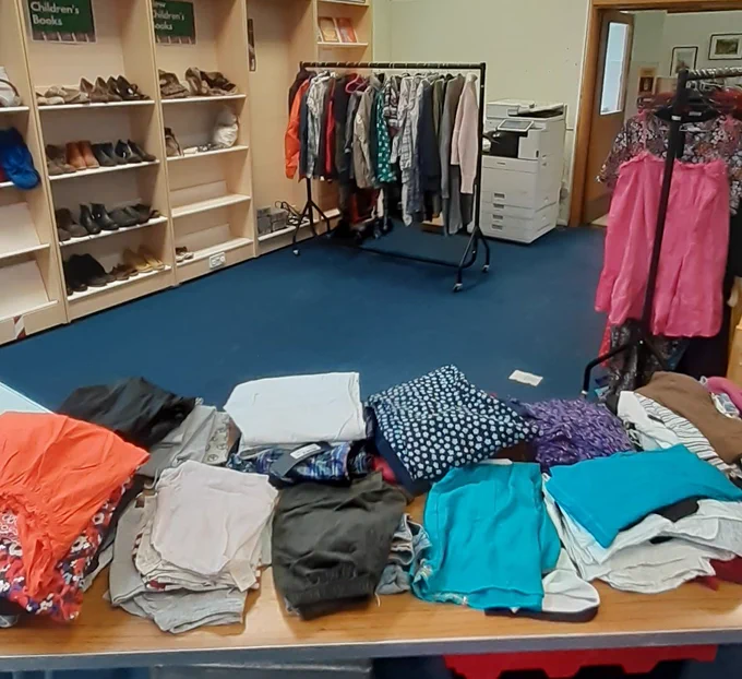 Clothes on a table and clothes rail