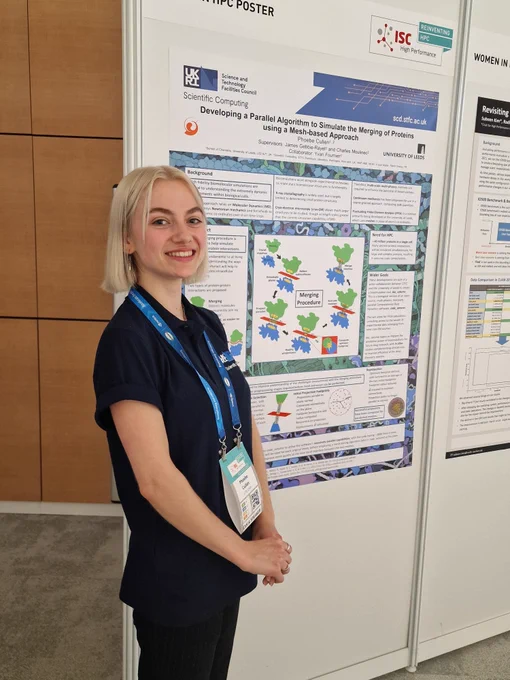 A girl standing next to a poster
