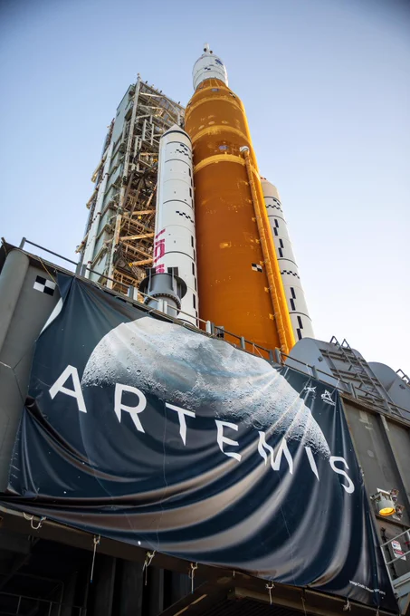 In this view looking up, NASA’s crawler-transporter 2 – adorned with an Artemis banner – can be seen bearing the weight of the agency’s Artemis I Moon rocket and mobile launcher as it carries the duo to Kennedy Space Center’s Launch Complex 39B in Florida on June 6, 2022. Credit: NASA/
